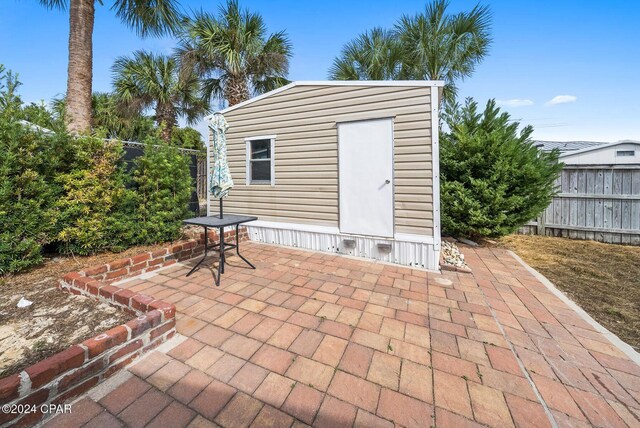 305 S Wells St, Panama City Beach, FL 32413 - view of outbuilding featuring fence and an outdoor structure