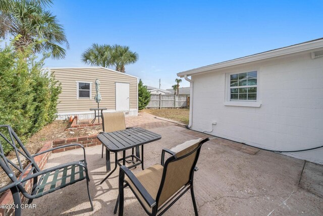 305 S Wells St, Panama City Beach, FL 32413 - view of patio / terrace featuring an outdoor structure and fence