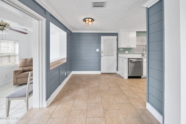 305 S Wells St, Panama City Beach, FL 32413 - kitchen featuring visible vents, white cabinetry, light countertops, dishwasher, and crown molding
