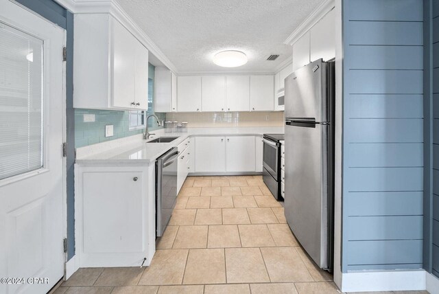 305 S Wells St, Panama City Beach, FL 32413 - kitchen featuring visible vents, decorative backsplash, stainless steel appliances, light countertops, and a sink