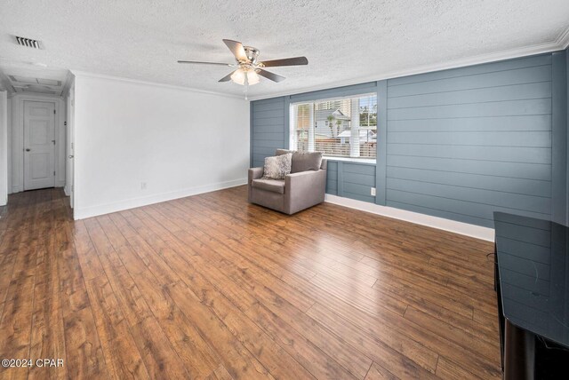 305 S Wells St, Panama City Beach, FL 32413 - unfurnished room with dark wood-style floors, visible vents, ornamental molding, ceiling fan, and a textured ceiling