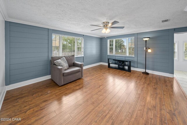 305 S Wells St, Panama City Beach, FL 32413 - unfurnished room featuring ornamental molding, visible vents, plenty of natural light, and wood finished floors