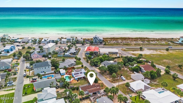 aerial view featuring a residential view, a view of the beach, and a water view