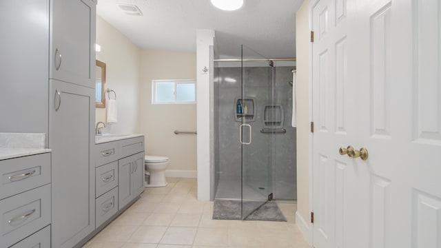 full bathroom featuring a stall shower, baseboards, toilet, tile patterned floors, and vanity