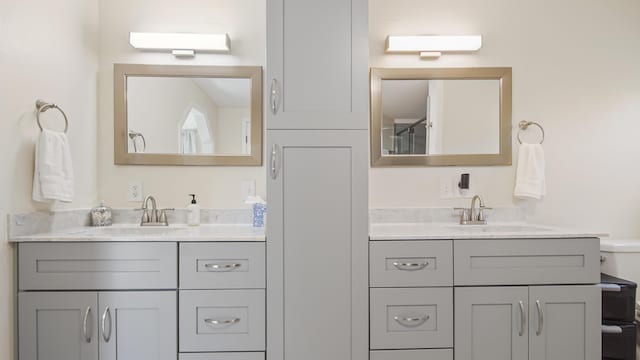 full bathroom featuring two vanities and a sink