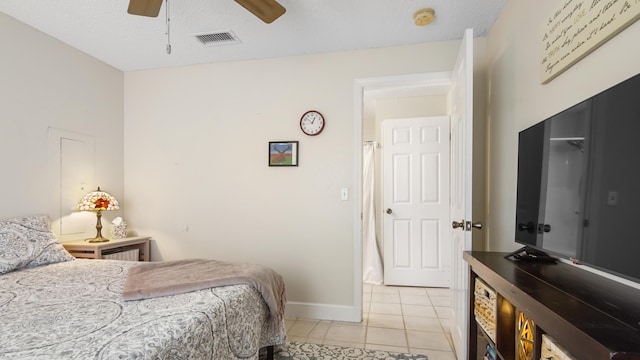 bedroom with light tile patterned floors, ceiling fan, visible vents, and baseboards