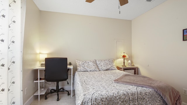 tiled bedroom featuring visible vents, a textured ceiling, a ceiling fan, and baseboards