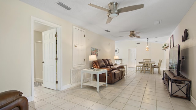 living area with light tile patterned floors and visible vents