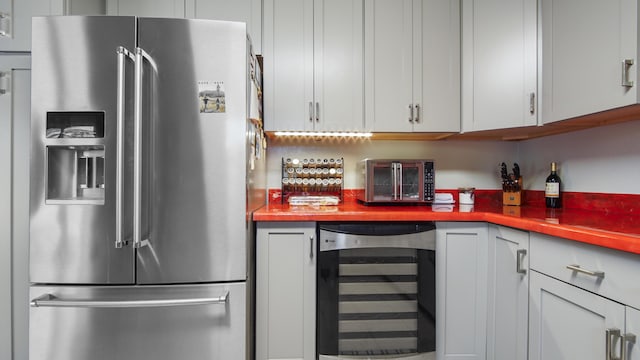 kitchen with light countertops, high quality fridge, and wine cooler