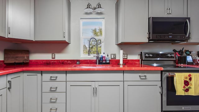 kitchen featuring appliances with stainless steel finishes and a sink