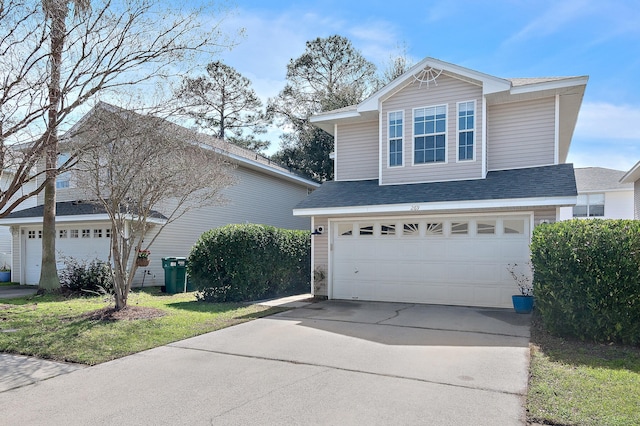 view of side of property featuring driveway, an attached garage, and a shingled roof