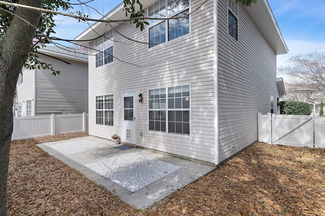 back of property with a patio and fence