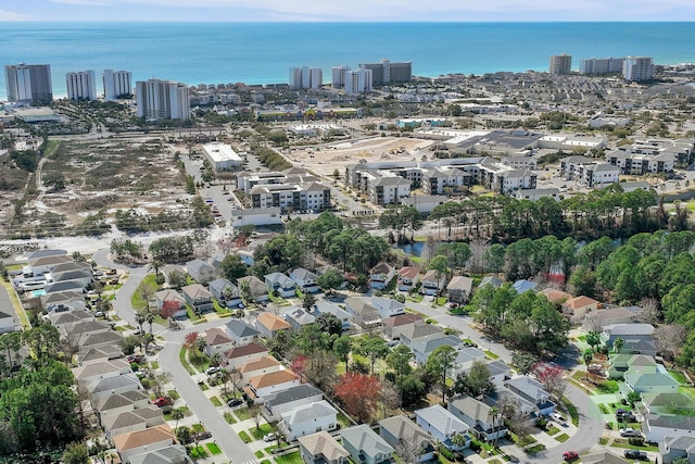 drone / aerial view featuring a view of city and a water view