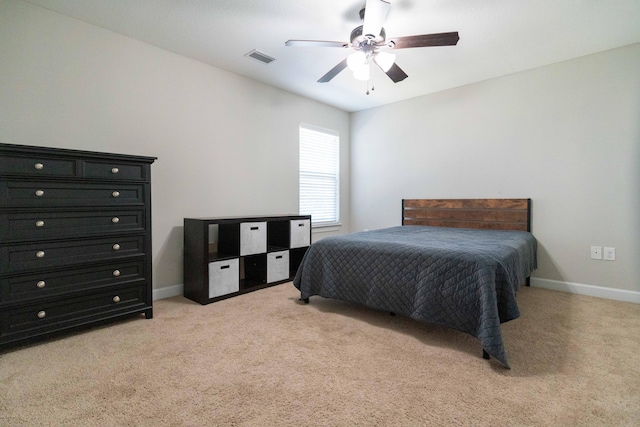 bedroom featuring light carpet, ceiling fan, visible vents, and baseboards