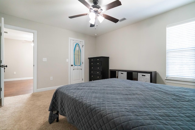 bedroom featuring a ceiling fan, carpet flooring, visible vents, and baseboards