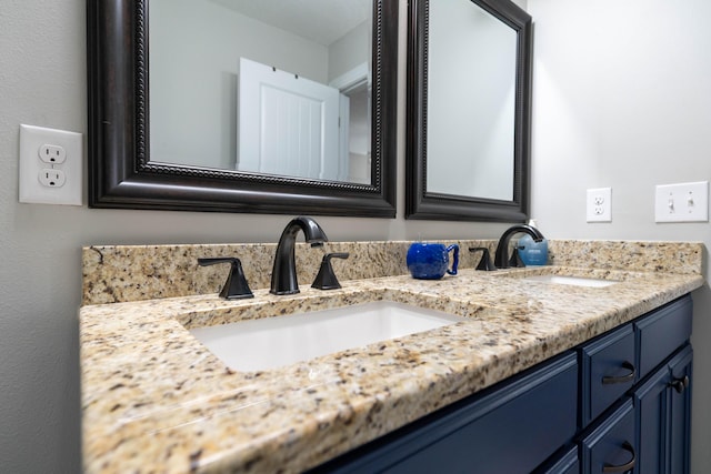 bathroom featuring double vanity and a sink