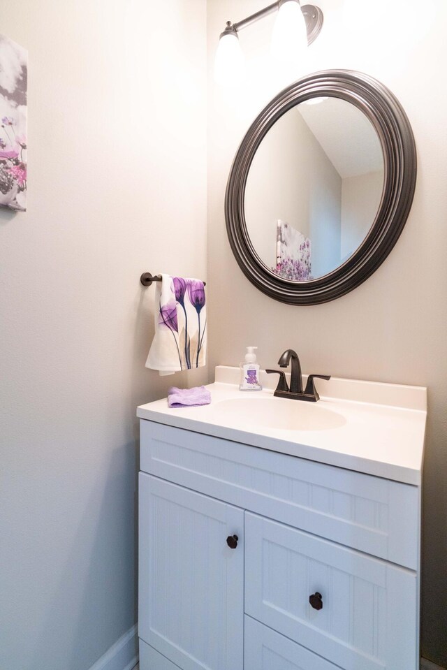 bathroom with baseboards and vanity