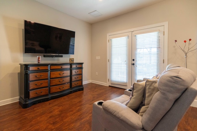 living room with dark wood-style floors, french doors, visible vents, and baseboards