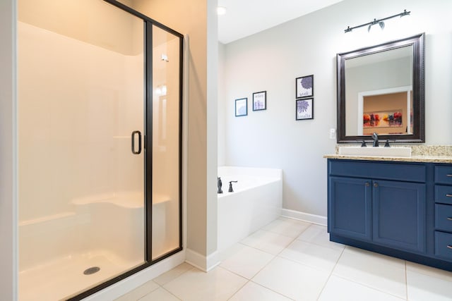 full bathroom featuring vanity, baseboards, a bath, tile patterned floors, and a stall shower