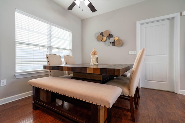 dining space with dark wood finished floors, a ceiling fan, and baseboards