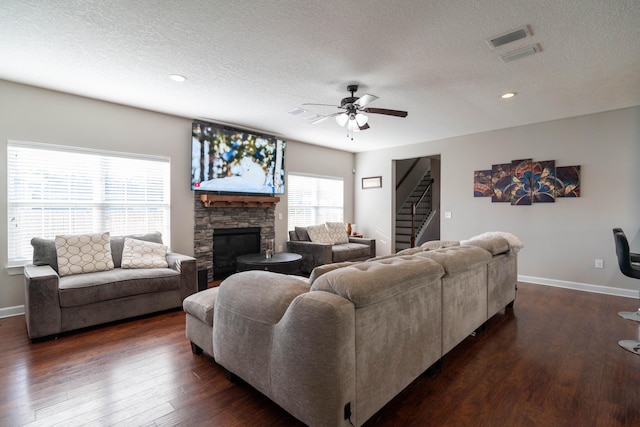 living room featuring dark wood finished floors, baseboards, and stairs