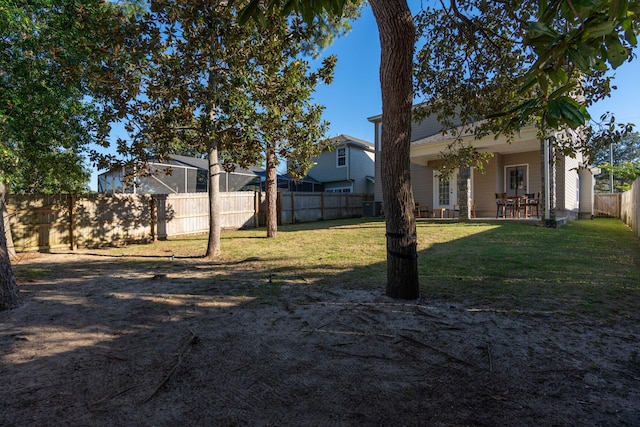 view of yard featuring a patio area, a fenced backyard, and central AC