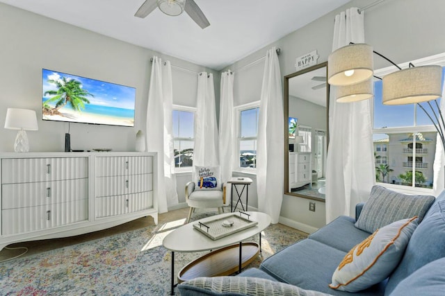 interior space with baseboards and a ceiling fan