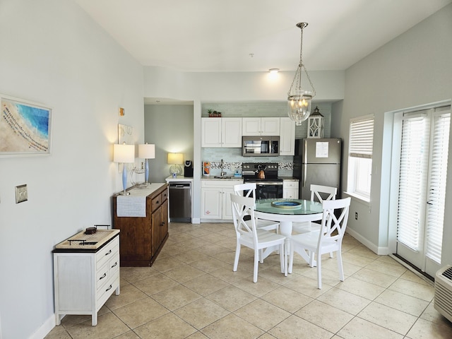 dining room with light tile patterned flooring, baseboards, and an inviting chandelier