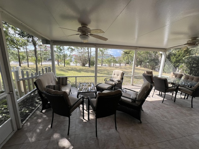 sunroom / solarium featuring a ceiling fan and a wealth of natural light