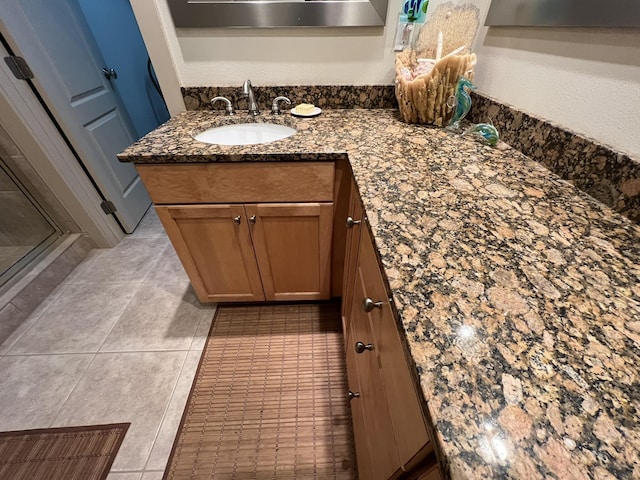 bathroom featuring a stall shower, vanity, and tile patterned floors