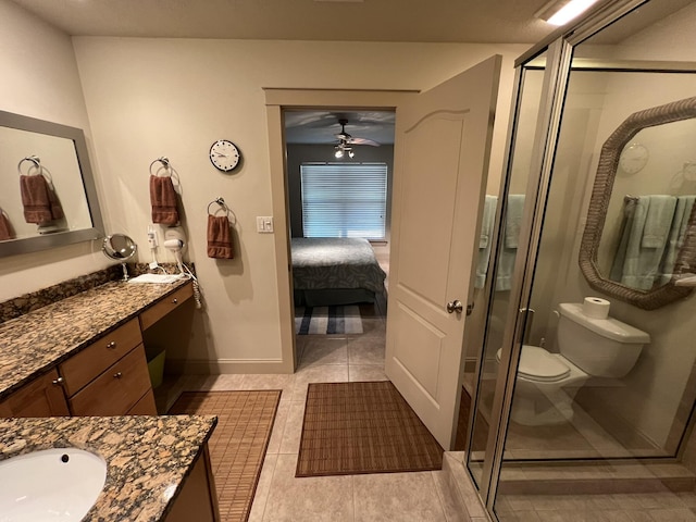 bathroom with toilet, ceiling fan, a shower stall, vanity, and tile patterned floors