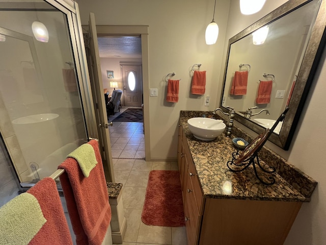 full bath featuring tile patterned flooring, a shower with shower door, vanity, and ensuite bath