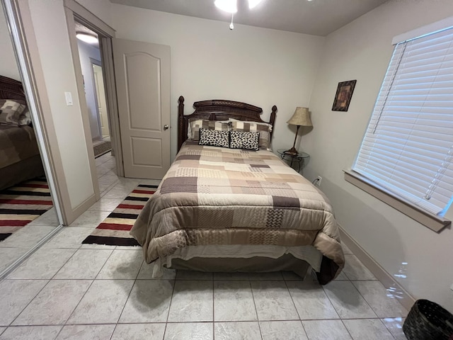 bedroom featuring baseboards and light tile patterned floors