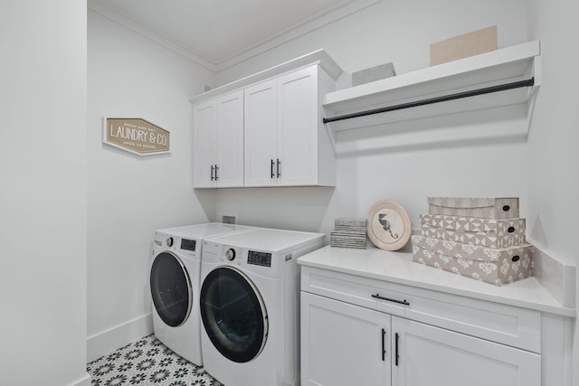 washroom with baseboards, washer and clothes dryer, cabinet space, and crown molding