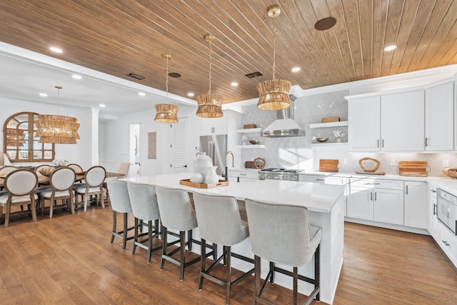 kitchen featuring open shelves, high quality fridge, wall chimney range hood, wooden ceiling, and range