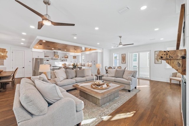 living area featuring dark wood-type flooring, recessed lighting, ornamental molding, and a ceiling fan