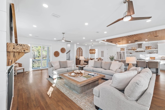 living room featuring ceiling fan, recessed lighting, wood finished floors, visible vents, and stairs