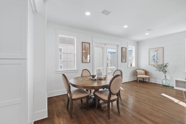 dining space with recessed lighting, dark wood-style flooring, crown molding, and baseboards