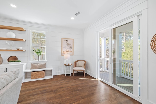 sitting room with dark wood-style floors, recessed lighting, crown molding, and baseboards