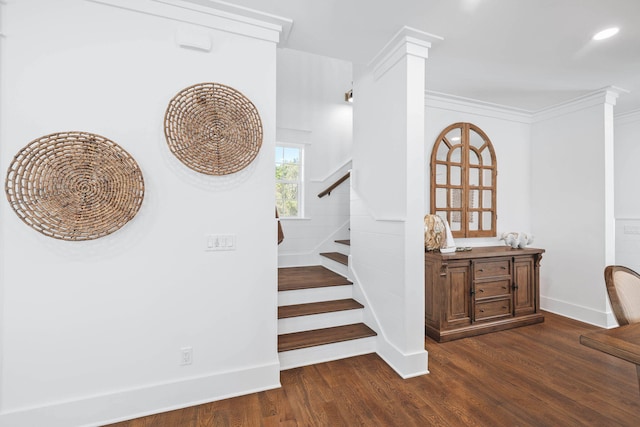 stairway featuring baseboards, crown molding, ornate columns, and wood finished floors