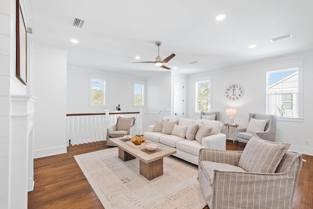 living room with ornamental molding, recessed lighting, dark wood-style flooring, and visible vents