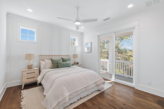 bedroom with access to exterior, visible vents, a decorative wall, and dark wood-type flooring