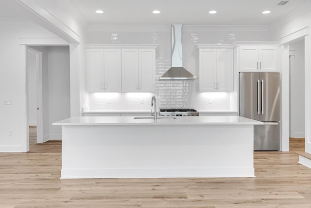 307 W Firethorn Cir Lot 42, Inlet Beach, FL 32461 - kitchen featuring an island with sink, light countertops, a sink, freestanding refrigerator, and wall chimney range hood