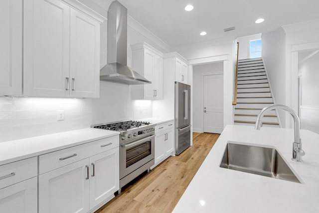 307 W Firethorn Cir Lot 42, Inlet Beach, FL 32461 - kitchen with light countertops, wall chimney exhaust hood, appliances with stainless steel finishes, white cabinetry, and a sink