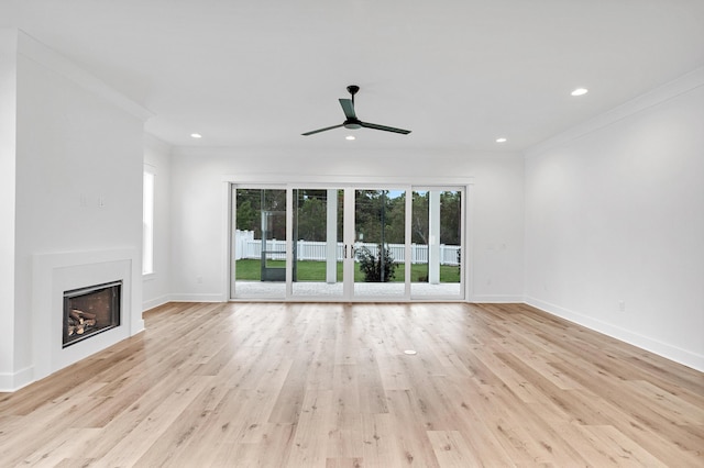 307 W Firethorn Cir Lot 42, Inlet Beach, FL 32461 - unfurnished living room featuring crown molding, a fireplace, light wood-type flooring, and a ceiling fan
