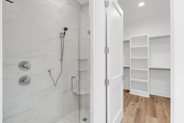307 W Firethorn Cir Lot 42, Inlet Beach, FL 32461 - full bath featuring a spacious closet, wood finished floors, and a shower stall