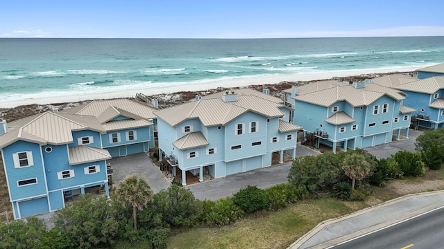 bird's eye view featuring a water view, a residential view, and a beach view