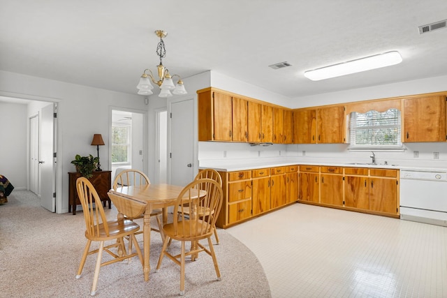 kitchen featuring a sink, visible vents, light countertops, and dishwasher