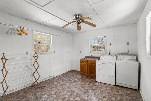 washroom featuring cabinet space, a sink, washing machine and clothes dryer, and ceiling fan