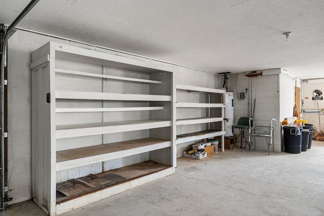 storage area with water heater and a garage